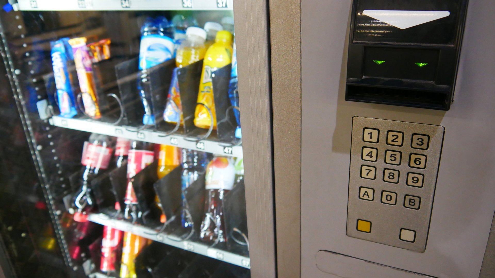 Close-up of vending machine with drinks and snacks