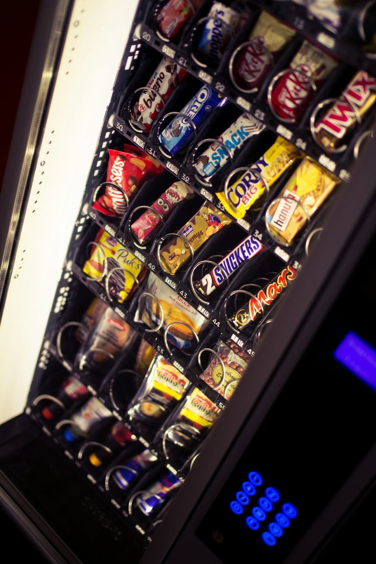 Vending machine stocked with colorful snack and candy products